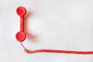 red phone on white table